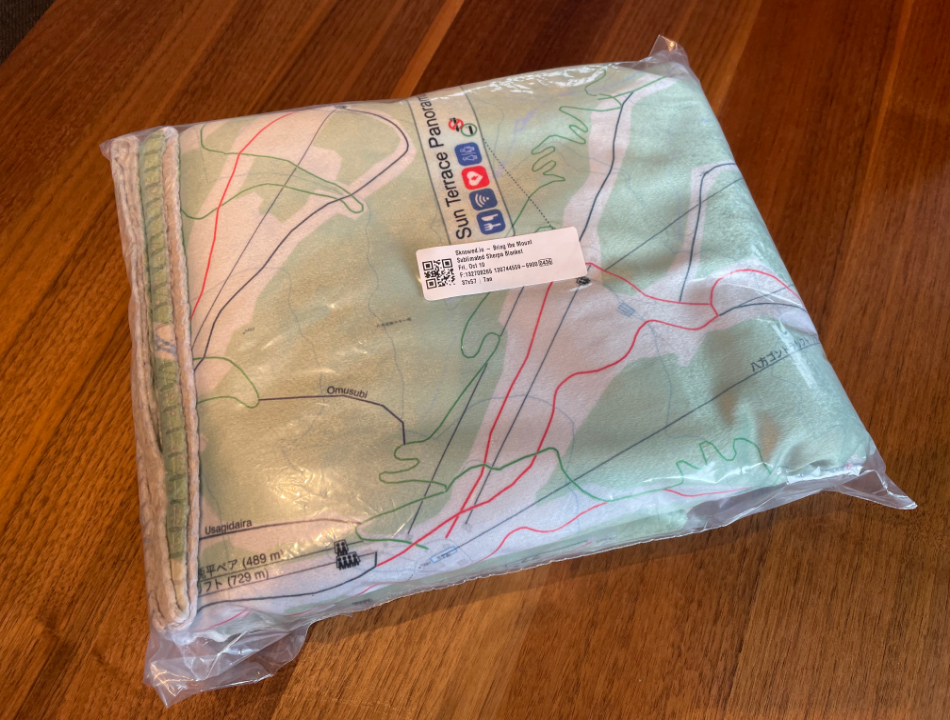 Hakuba ski map blanket inside packaging showing print quality and material detail